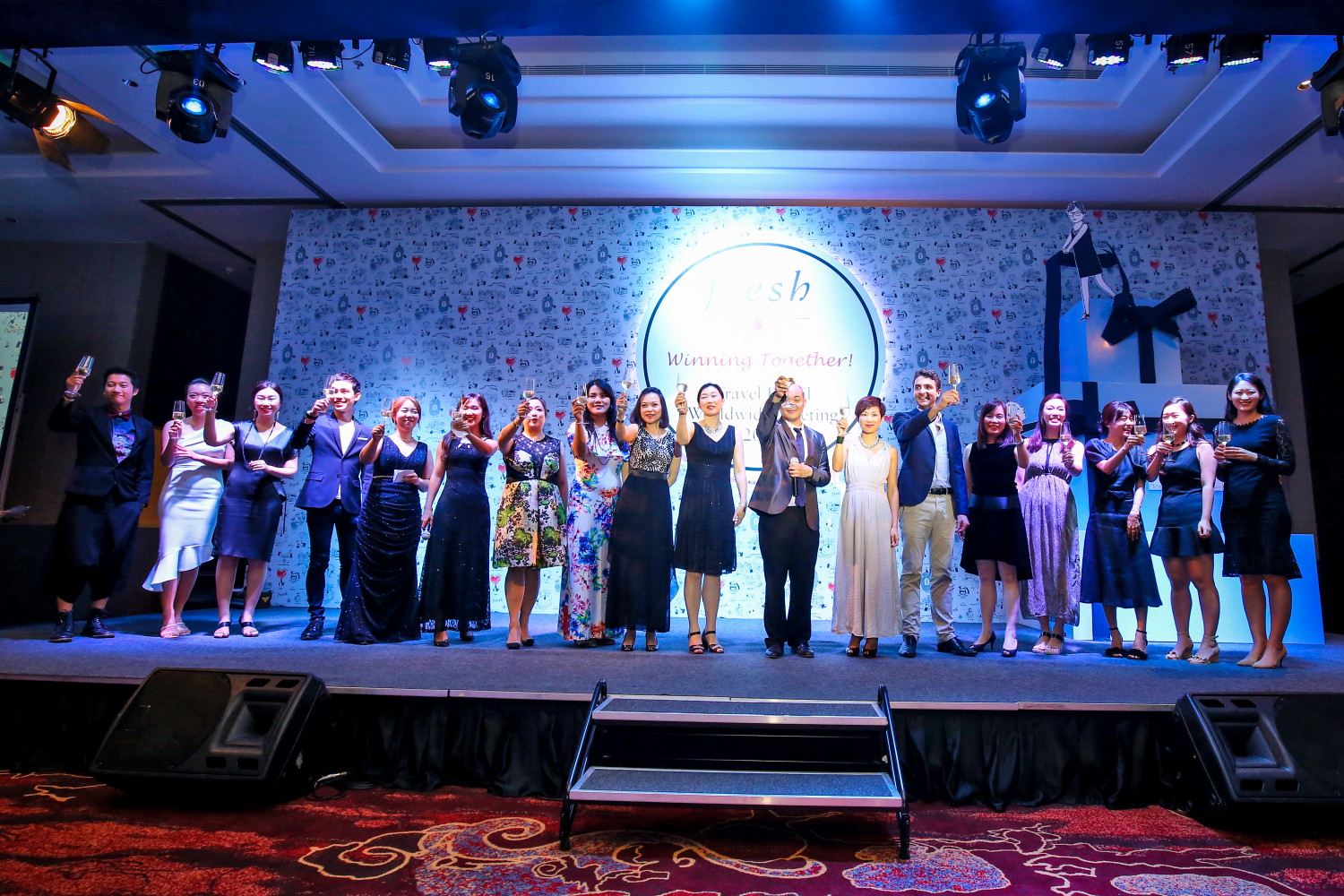 Corporate guests raising a toast on stage in Bali