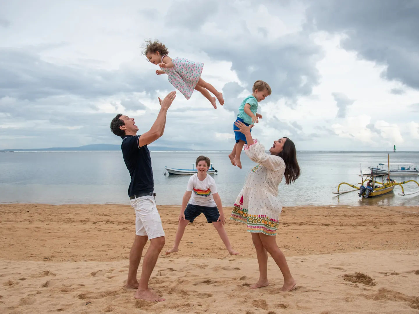 Parents playing with their children on a Bali beach