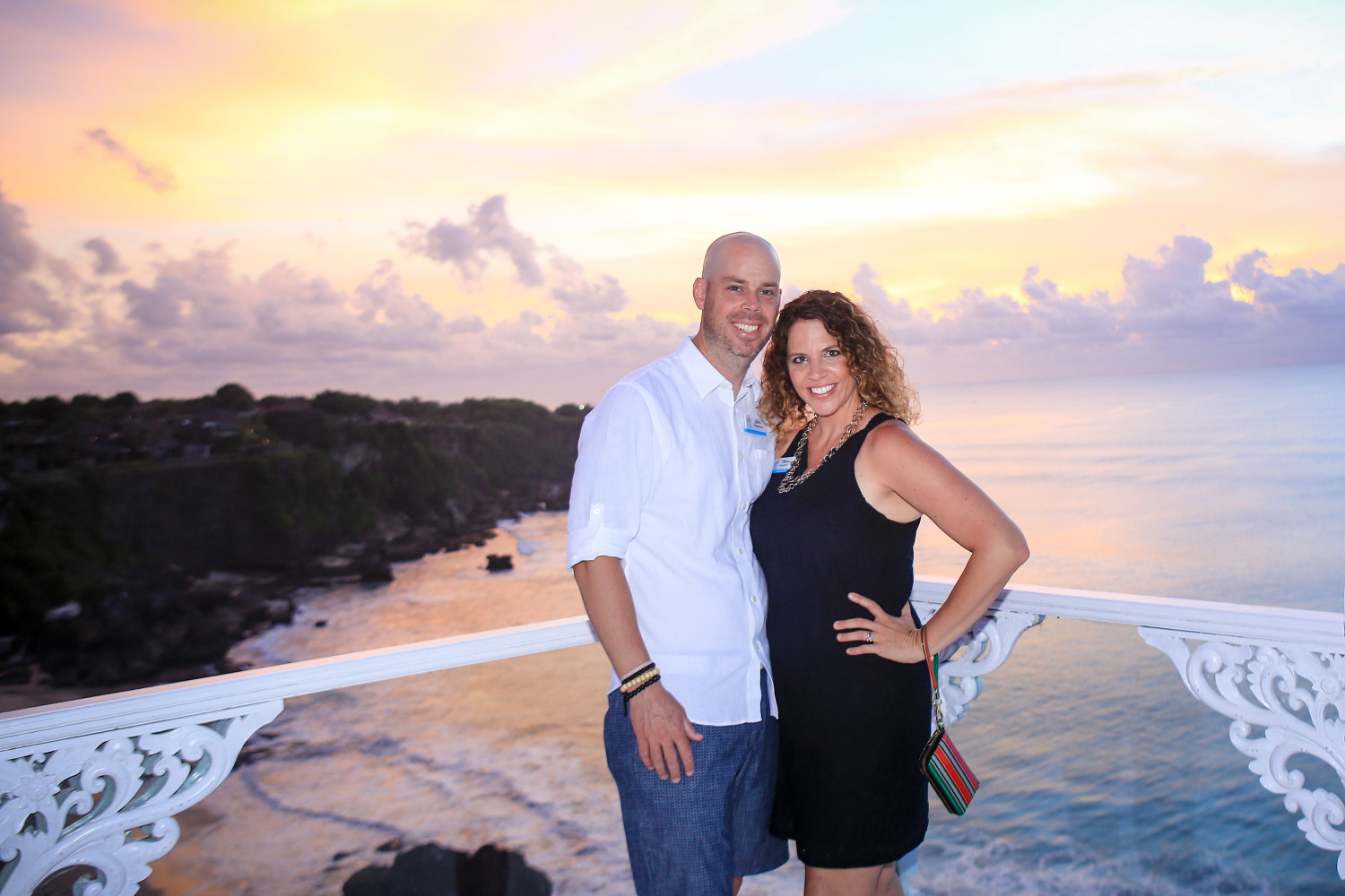 Couple photographed at sunset above the Bali coastline